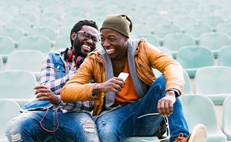 Two friends smiling outside