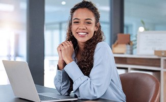 Woman smiling while working in office