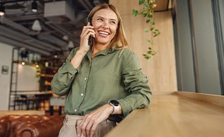 Woman smiling while talking on phone