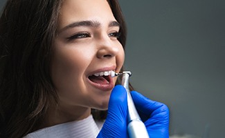 Young woman having her teeth cleaned