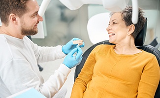 Dentist discussing treatment with older woman