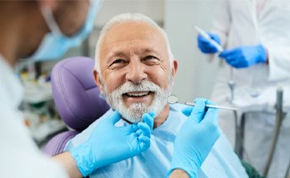 Senior man smiling at dentist during checkup