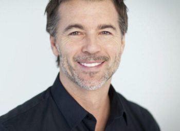 Smiling man in black polo shirt