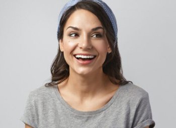 Smiling woman wearing gray shirt and beanie