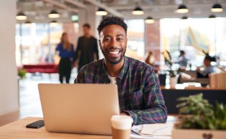 Man smiling while working in office