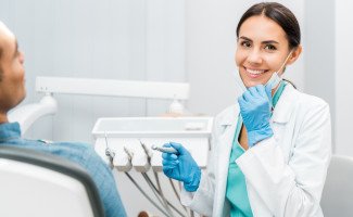 Dentist smiling at patient's dental exam