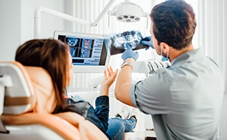 a dentist and patient viewing an X-ray image