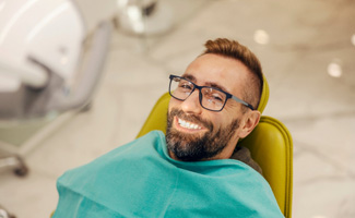 Smiling man leaning back in the dental chair