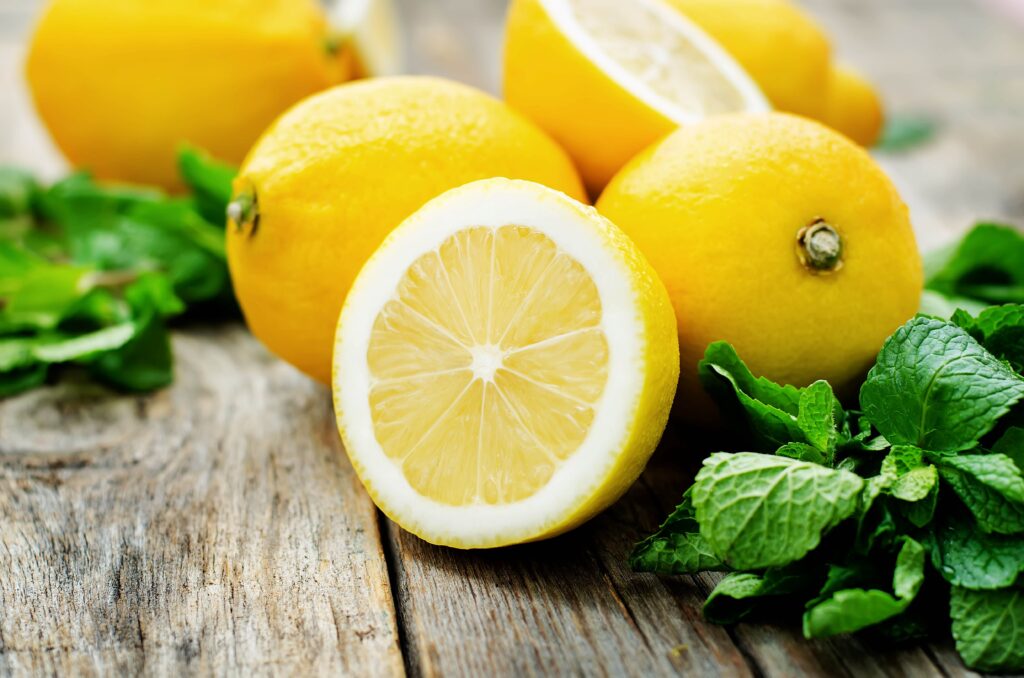 Several lemons lying on rustic table