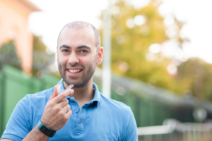 a patient holding their Invisalign aligner